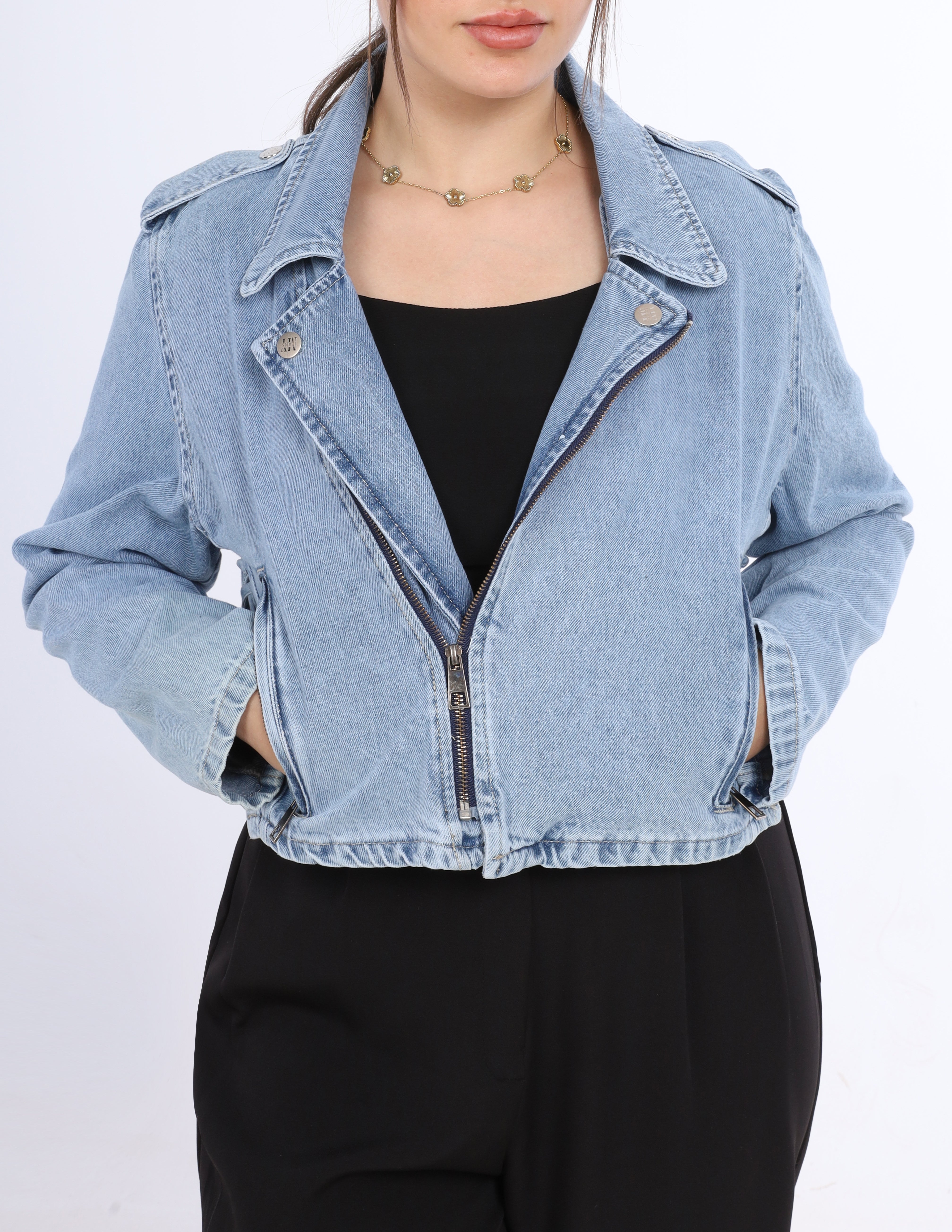 Denim jacket worn by a person on a white background